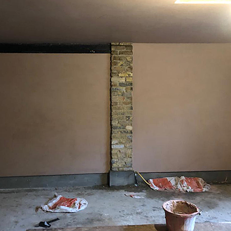 Damp proofing and plastering an old garage